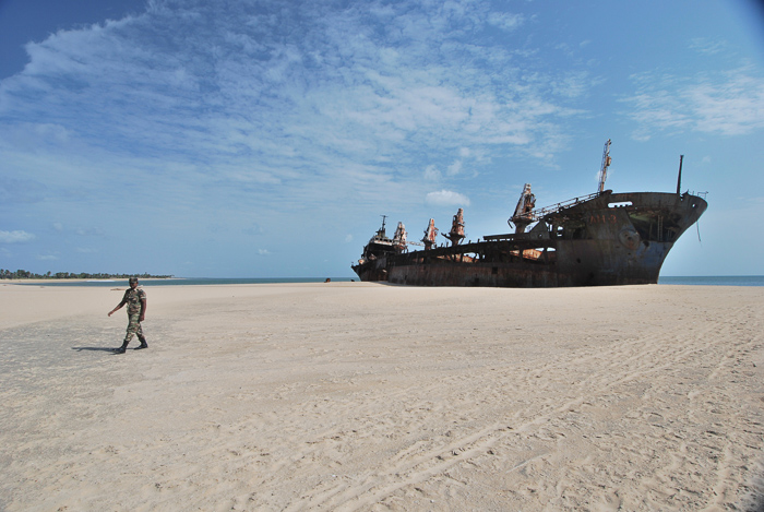 shipwreck on beach and soldier